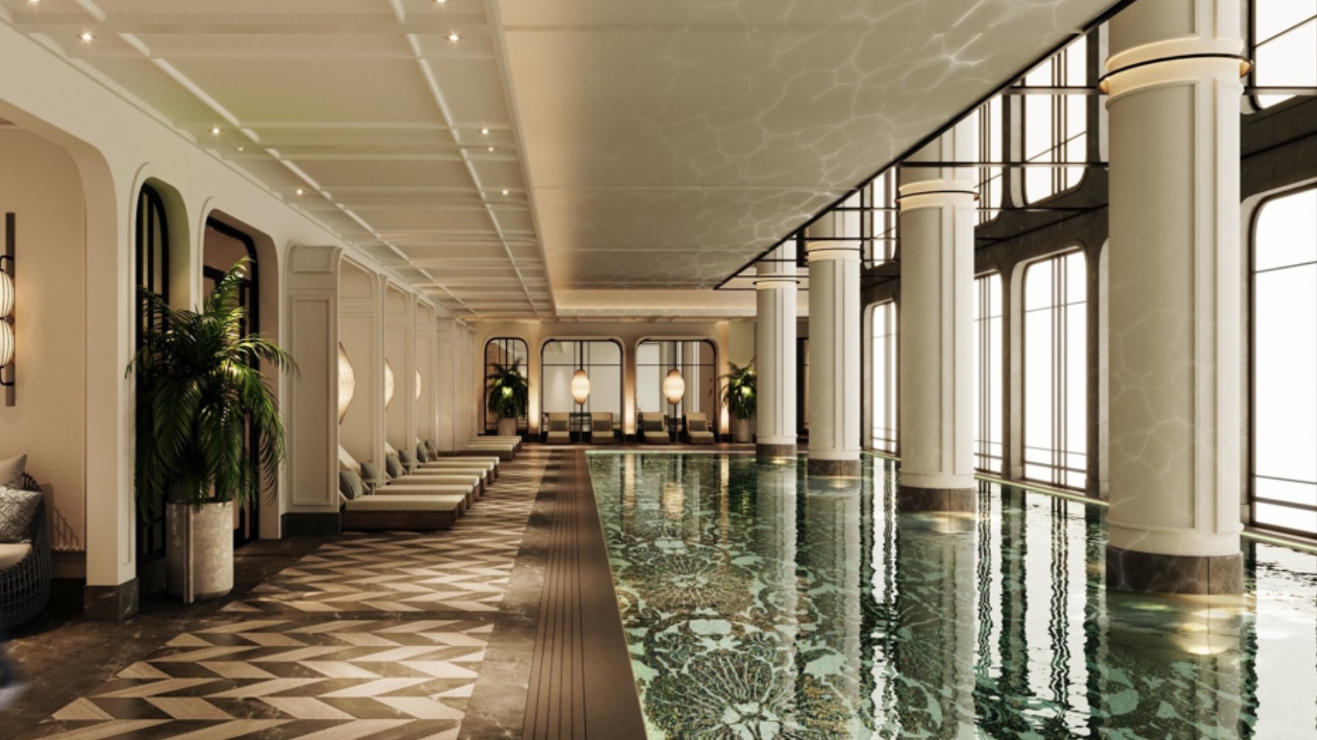 Indoor residents pool with patterned stone flooring, arched openings and full-height glazing
